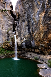 Waterfall and idyllic lake in the Pyrenees Rio de Escarra Escarilla Spain 