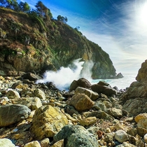 Waves crash against the rocky coast of Big Sur California 