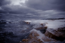 Waves crashing into frozen beach - St Joe MI