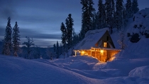 Wintry cabin at sunset 