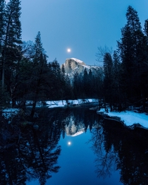 Wintry reflections of Half Dome with a full moon rising above it in Yosemite National Park  x
