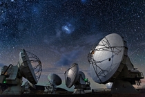 With the familiar Large Magellanic Cloud at top center beckoning in the sky above six of the giant dishes forming the Atacama Large Millimetersubmillimeter Array ALMA stand by 