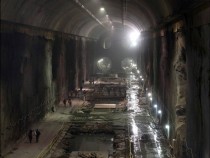 Workers walk through a massive eight-story cavern at the East Side Access project beneath midtown Manhattan The project will bring subway and commuter rail service to the far East and West sides of the city  Mary Altaffer AP 