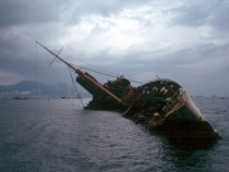 Wreck of the former RMS Queen Elizabeth then the worlds largest capsized in Victoria Harbor after ravaged by fire in  where it remained in various stages of deconstruction until it was finally buried as part of a land reclamation project in the Bay of Hon