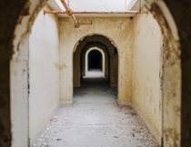 Yellow hallway in an abandoned mental hospital