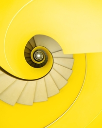 Yellow spiral staircase in a car park by Strausak Associs  Geneva Switzerland 