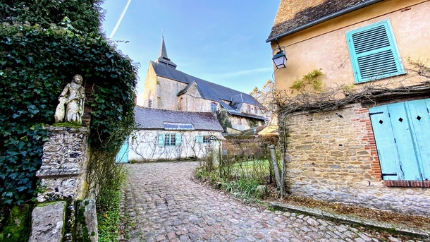  France - Village of Gerberoy - View of the Collegiate Church of Saint-Pierre de Gerberoy from the rue Henri le Sidaner