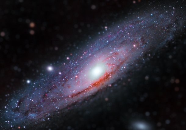  Million light-years away from earth this is the Andromeda Galaxy This image is comprised of  main images each taking many hours to complete This allows you to see the pockets of Hydrogen Alpha in the galaxy and all the fine details