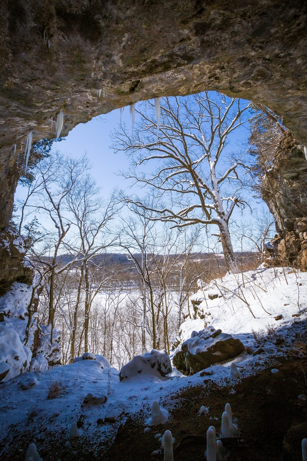  Yawning mouth of an Ozark cave opens to a bright and icy winter midday x