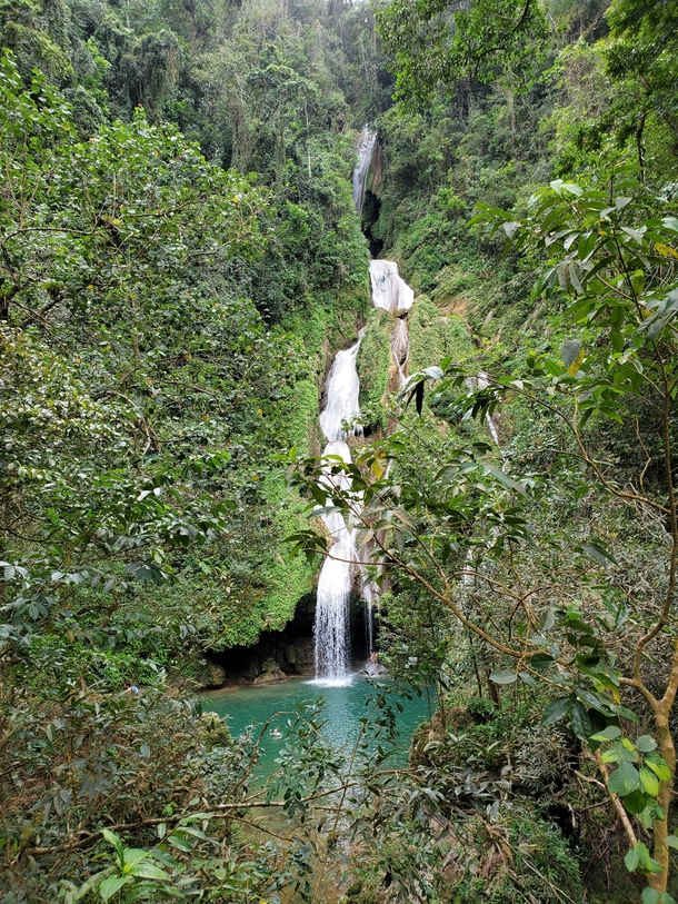 A beautiful waterfall with crystal clear water somewhere in the middle of a Cuban rainforest 