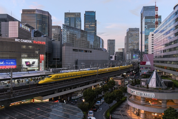 A bullet train pulls into Yurakucho station Tokyo Japan