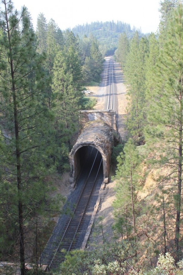 A cave in has been cleared leaving the stand-alone portal and a gap to the rest of the rail road tunnel Applegate California USA 
