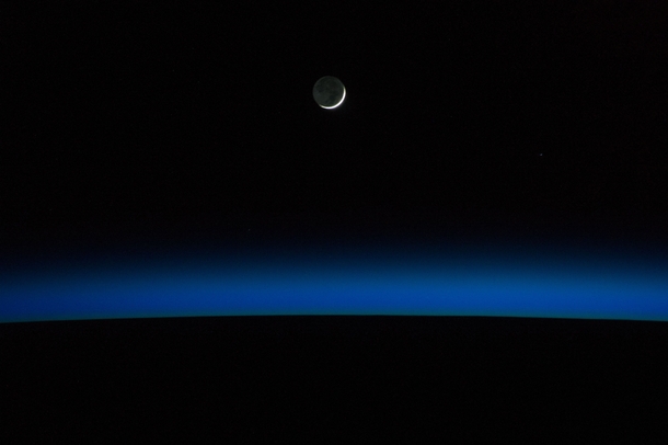A crescent moon and Earths horizon are featured in this nighttime image photographed by an Expedition  crew member on the International Space Station May   