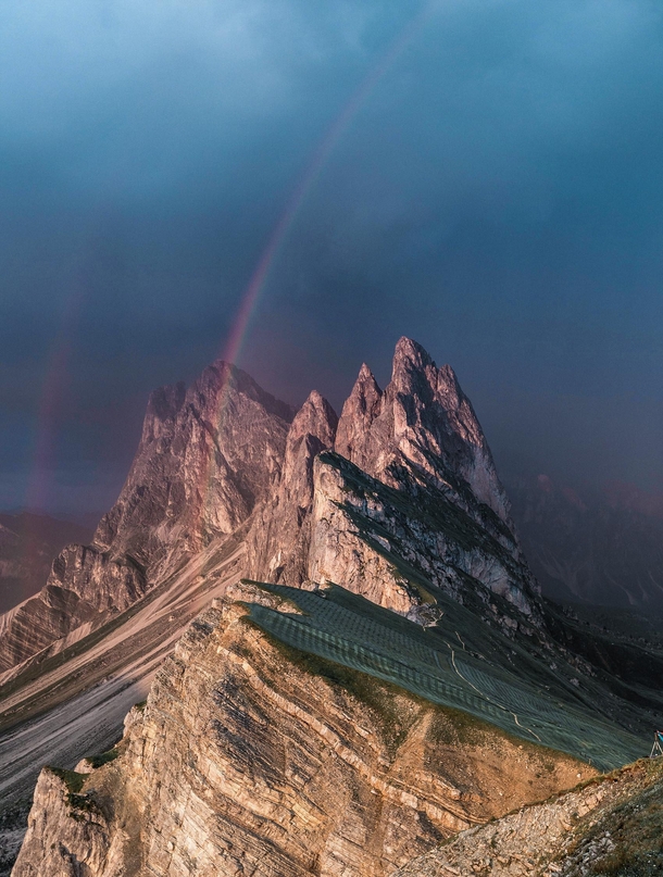 A double rainbow arcing over the peaks of Sass Rigais in Italy 