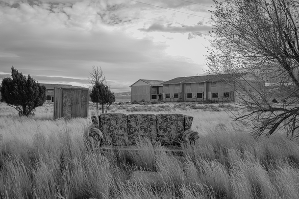 A Floral-Print Couch in an Overgrown Field in a Abandoned Wyoming Ghost Town 