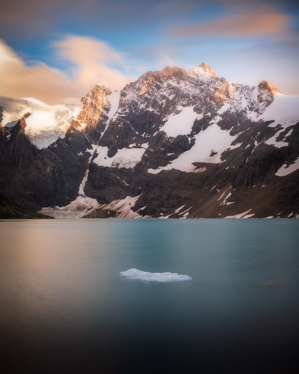 A friend and I made a campfire right on the shore here and had this view to ourselves for a whole day A couple storms passed by throughout but we were gifted this in the evening Lake of the hanging Glacier in BC Canada 