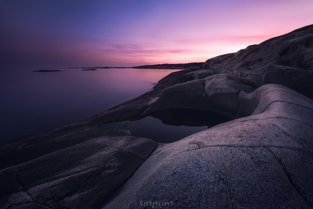 A glacial pothole during  s of sunset at the Norwegian south coast 