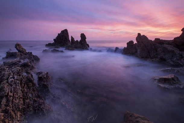 A long exposure during high tide and the pinkest sunset Ive ever seen in Corona Del Mar CA 