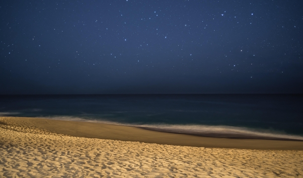 A long exposure shot at midnight on the beach in Cabo San Lucas Mexico 