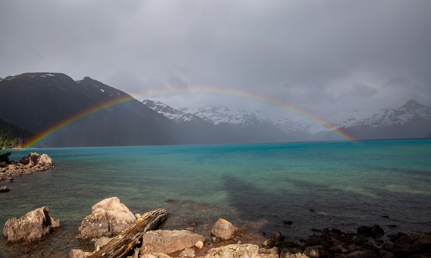 A momentary break in the storm for a perfect mountain lake rainbow Garibaldi Lake BC 
