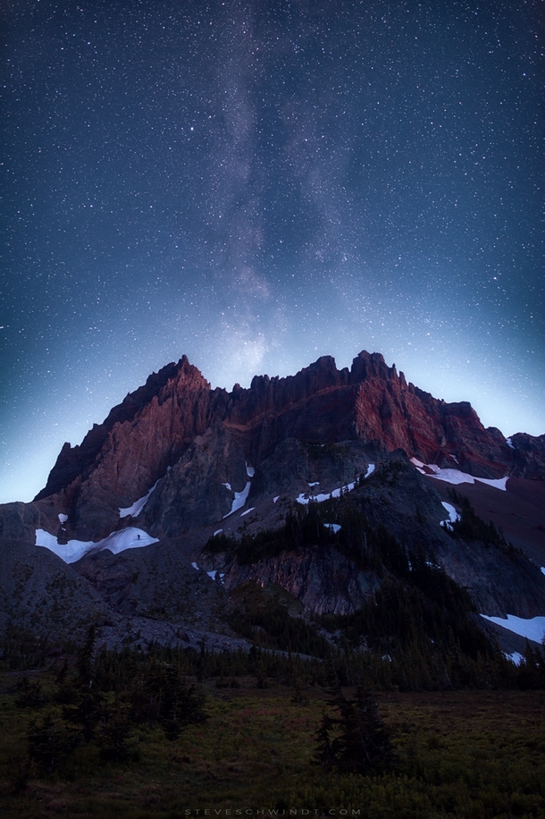 A nearly full moon sets behind Three Fingered Jack in Oregon obscuring the Milky Way core but providing an incredible glow behind the mountain 