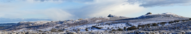 A panoramic view of some tors in Dartmoor Devon the nearest on the right is Saddle tor with Hay tor behind and to the left The tors found in this moorland which covers  square kilometres  sq mi and is protected as the Dartmoor National Park Photo Herbythy