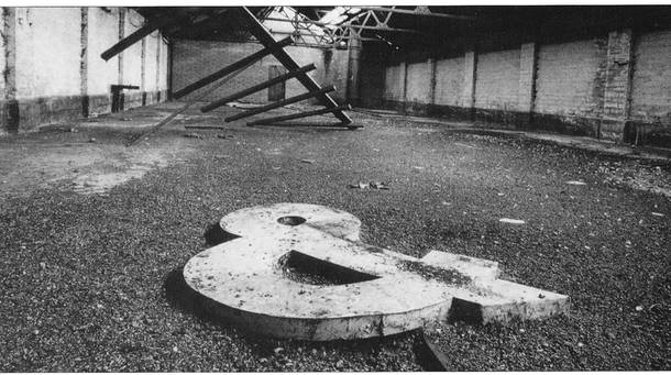 A photo taken in an abandoned factory in my town called the Irish Oil amp Cake Mills where its ampersand lies forlorn The building has since been demolished and replaced with the car park of a shopping centre