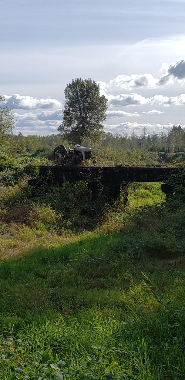 A tractor on a trestle both left to rust and rot