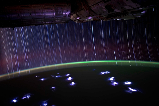 A view from the ISS - Star trails and satellite flashes above lightning storms below 