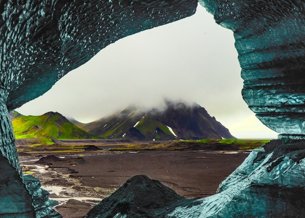 A view of Iceland seen from inside a melting ice-cave 