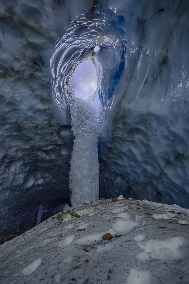 A view to the outside through a frozen waterfall inside a glacier cave on Mt Hood Oregon  Photo by Jason George