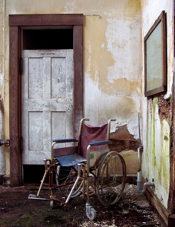 A wheelchair in front of a patients bathroom Taken at the now demolished Repair Shop at the former Foxboro State Hospital 