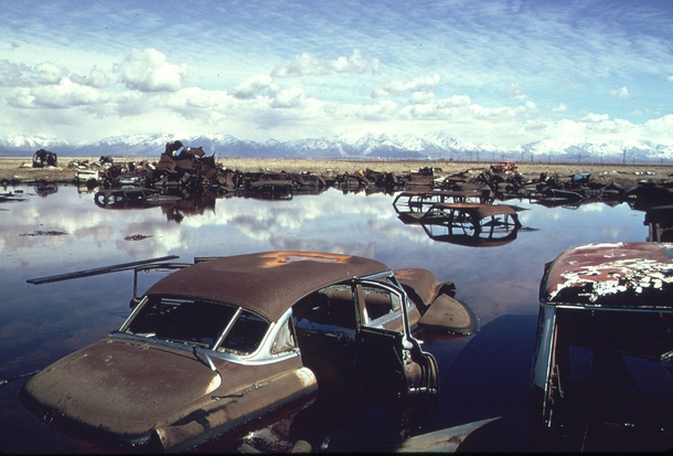 Abandoned automobiles and other debris clutter an acid water and oil filled five acre pond near Ogden Utah in April of  It was cleaned up under EPA supervision to prevent possible contamination of the Great Salt Lake and a wildlife refuge nearby Bruce McA