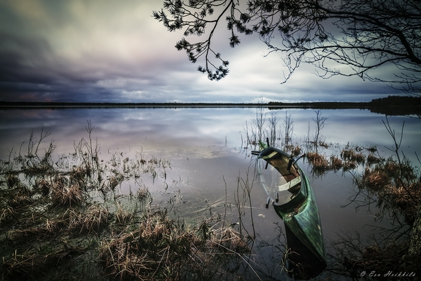 Abandoned canoe at a small lake in Finland  by Esa Heikkil