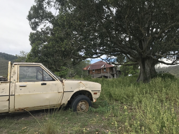Abandoned car and homestead in isolated rural Queensland