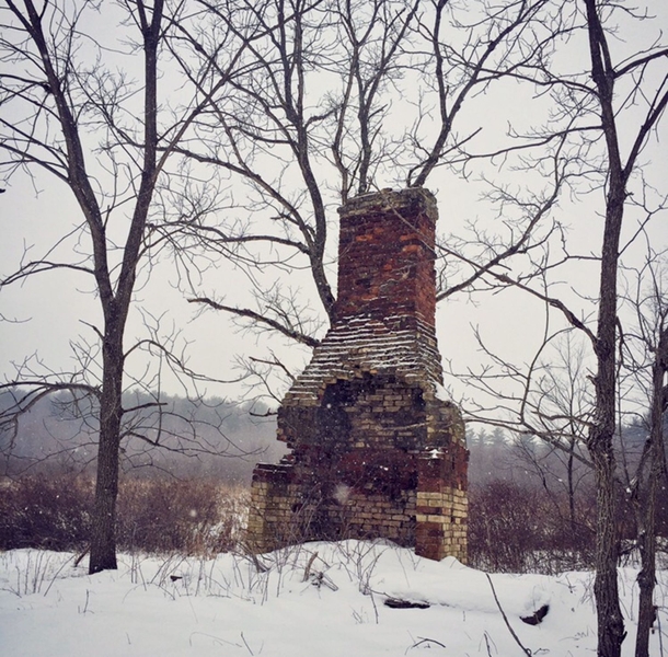 Abandoned chimney during a snowstorm Pennsylvania 
