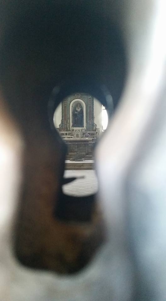 Abandoned church in Trevico Italy as seen through the keyhole of the front doors 