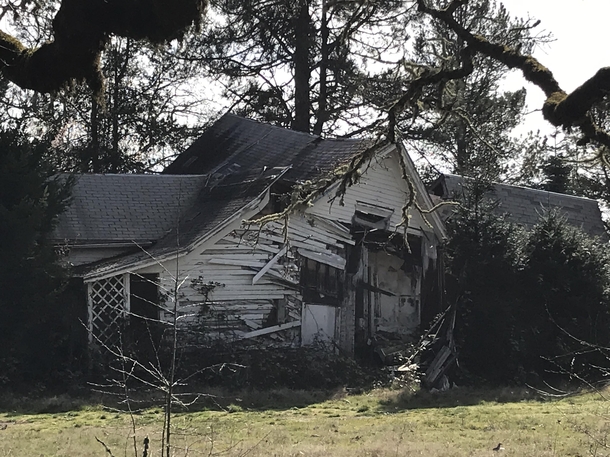 Abandoned farm house next to a graveyard
