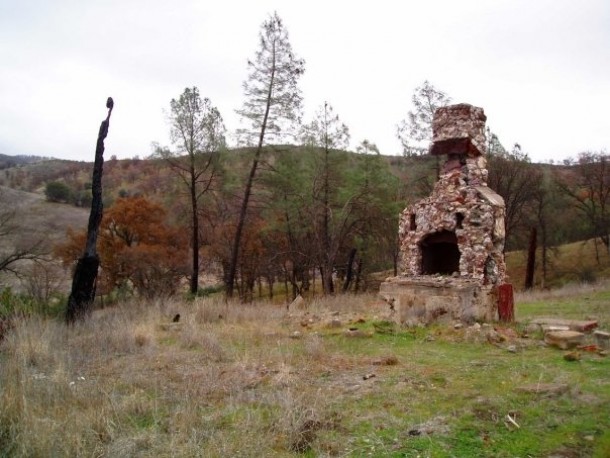Abandoned fireplace on foundation remains of long-gone cabin just north of Lake Berryessa in Napa CA 