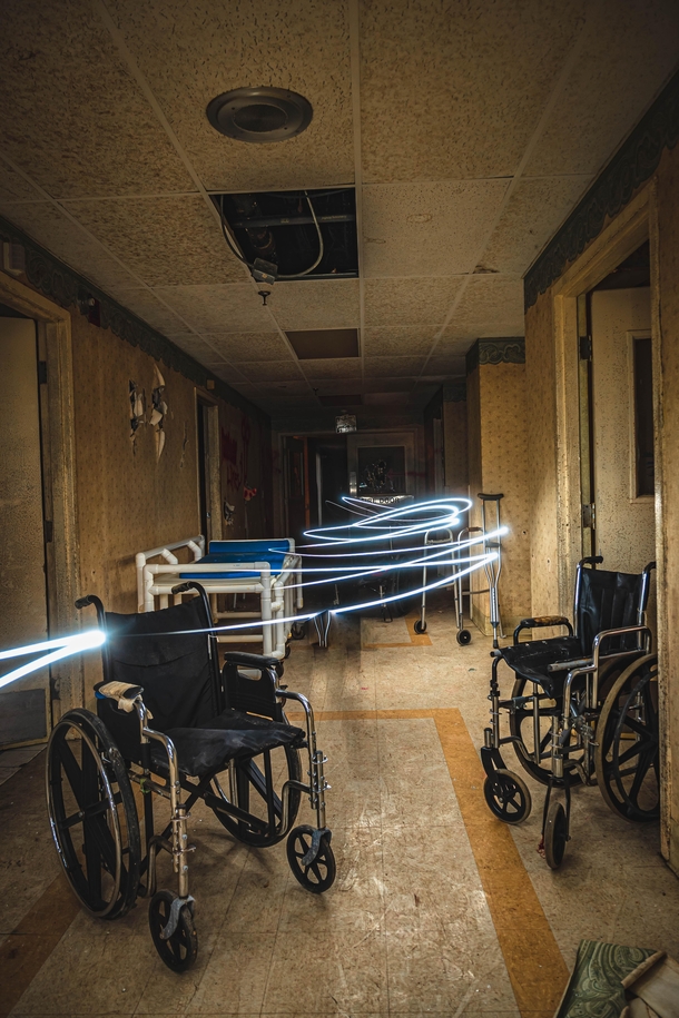 Abandoned hospital hallway with equipment