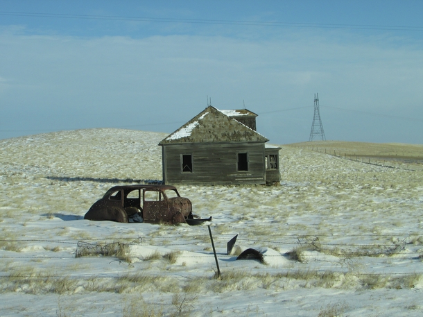 Abandoned house and  Ford riddled with bullets - somewhere west of Dunn Center ND 