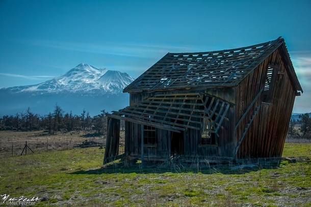Abandoned house on an old nature conservancy with Mount Shasta in the distance