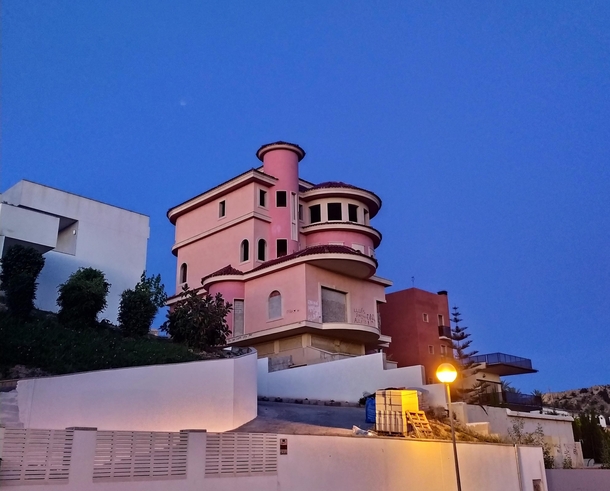 Abandoned pink mansion in the middle of a residential area in Alicante Spain