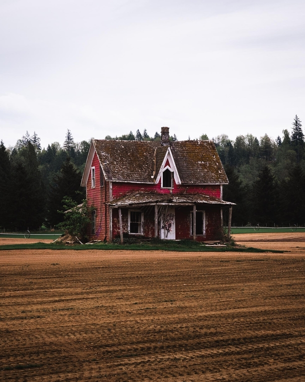 Abandoned Red House in the middle of a field in Langley BC