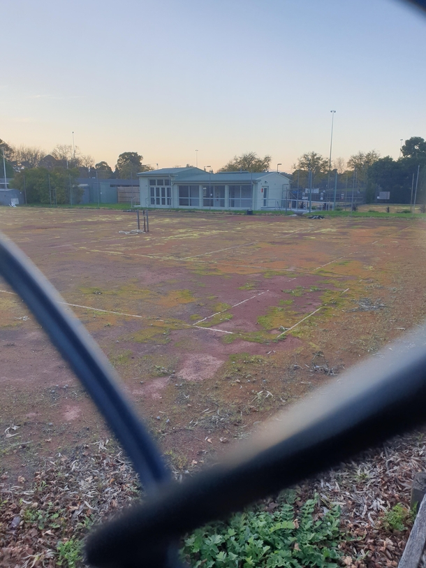 Abandoned tennis court in a public park near me