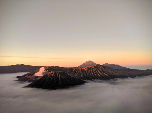 Above the clouds volcanos at sunrise Bromo Tengger Semeru National Park East Java Indonesia 