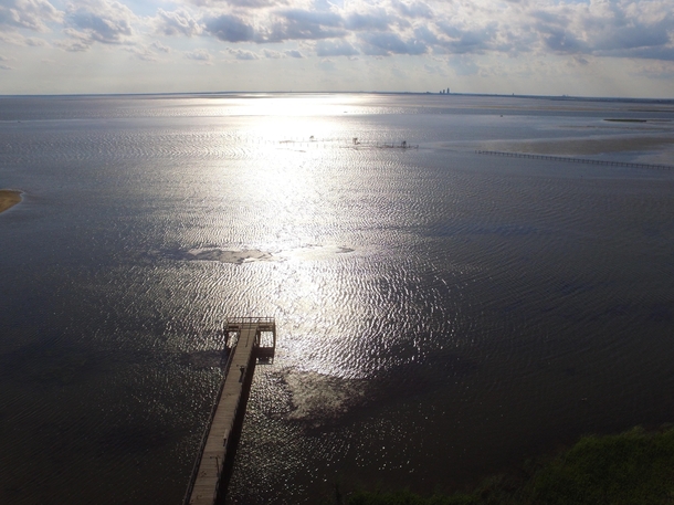 Aerial of Daphne pier late afternoon Mobile Bay and the city on the horizon  OC