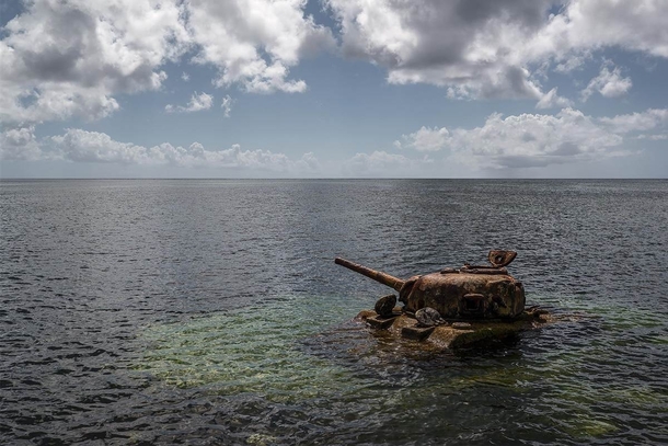 An abandoned A US Sherman tank off the coast of Saipan that has been the playground of reef fish since World War II 