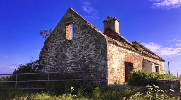 An abandoned building along the countryside road in Ireland 