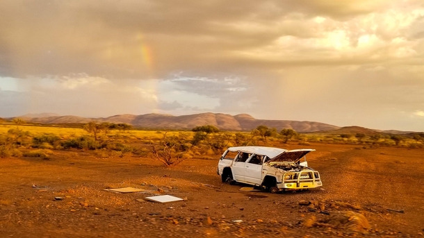 An abandoned car in the middle of nowhere Australia drive by shot